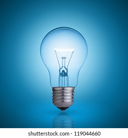 Light Bulb On Blue Background.