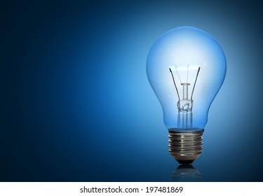 Light Bulb On Blue Background.