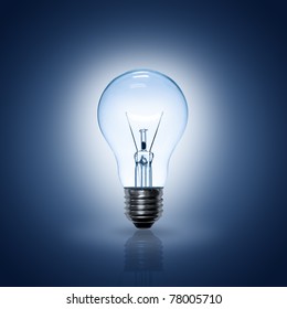 Light Bulb On Blue Background.