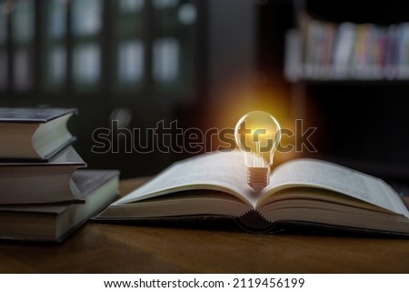 Light bulb on the open book, Idea concept for innovation idea, power of knowledge, power of reading, Self-learning, and education knowledge.