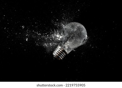 light bulb shattering on black