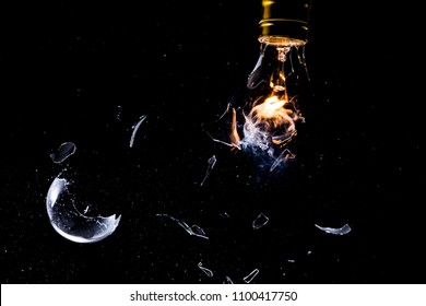 A light bulb shattering while lit, with flame and smoke and stop action on shattering glass - Powered by Shutterstock