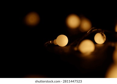 Light bulbs glowing against backdrop of golden bokeh