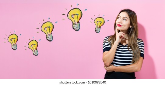Light Bulbs with young woman in a thoughtful pose - Shutterstock ID 1010092840