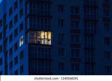 the light burns in one window of the multitude in a multi-storey residential building
 - Shutterstock ID 1140568241