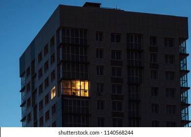the light burns in one window of the multitude in a multi-storey residential building
 - Shutterstock ID 1140568244
