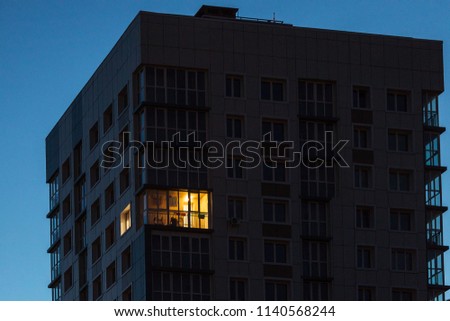 the light burns in one window of the multitude in a multi-storey residential building
