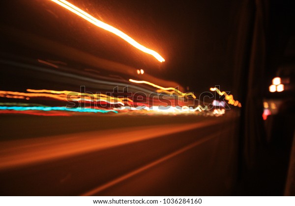 The light from the car at speed at night.Subject\
is blurry.
