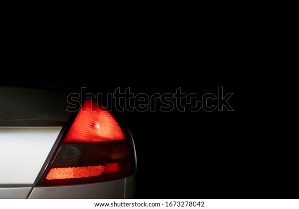 The light\
from the car tail lights in the\
dark.