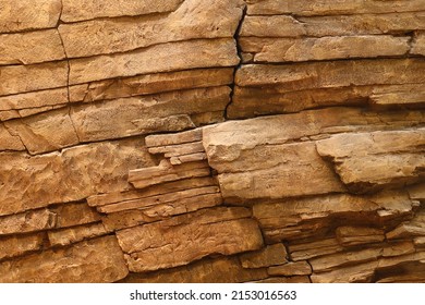 Light Coarse Natural Rock Stone Background. Mining Cliff Rough Front Surface. Big Limestone Stack Backdrop. Heavy Grunge Damaged Granite Block Texture. Crack Antique Medieval Stony Facade For Design