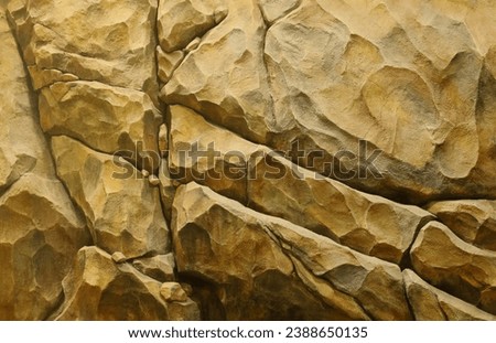 Light coarse natural rock stone background. Mining cliff rough front surface. Big limestone stack backdrop. Heavy grunge damaged granite block texture. Crack antique medieval stony facade for design