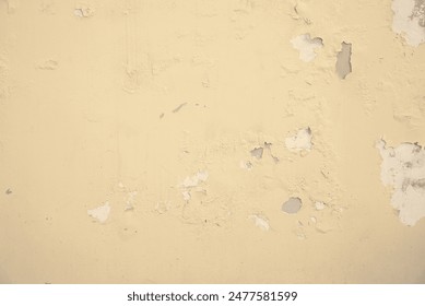 Light color paint peeling from the wall. Moisture damage. Texture