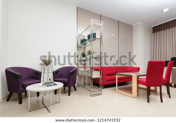Light\
designed modern living room divided by\
bookcase
