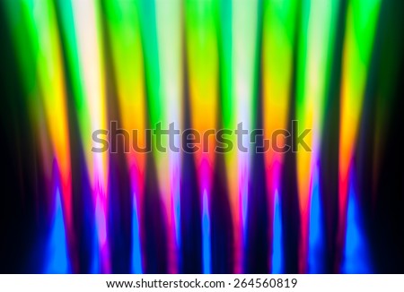 Light dispersion from a compact disk surface. Rainbow effect.