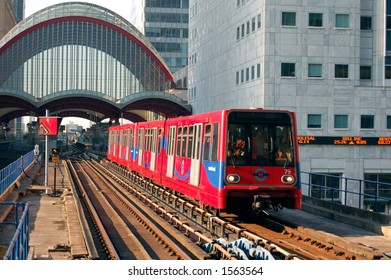 Light DLR railway train approaching the station at Canary Wharf, London
