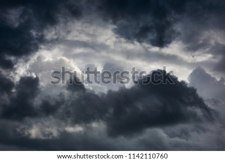 Light in the dramatic. Thunderstorm clouds in the dark sky. Summer rainy weather. In the evening before the storm.
