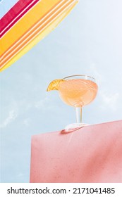 Light Drinks. Bottom View Of Cocktail Glass With Champagne, Martinez Drink Over Blue Sunny Sky Background. Vacation, Happiness, Summer Vibes. Retro Style Photo. Tropical Climate