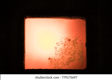 light during high temperature solidification of molten metal in sand mold after pouring; iron casting process ; industrial backgound
