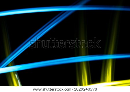 Light effect background. Multicolored luminous tracks in the dark.