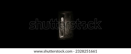 Light entering through a narrow rectangular window of an old fortified castle with the whole room in darkness and a lot of sinister and terrifying space