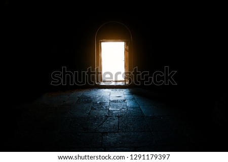 Light entering through open door to a dark room