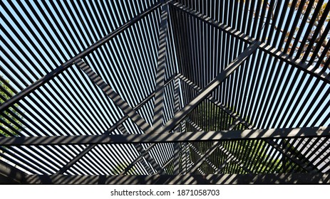 Light Filter Steel Roof Structure. The Black Metal Roof Structure Of The Modern House Filters The Light In The View Below. On A Full Frame Natural Background. Selective Focus