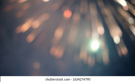 The light of fireworks filled the dark sky. There are red, orange, and big green sparkles that are the abstract background blur. - Shutterstock ID 1634274790