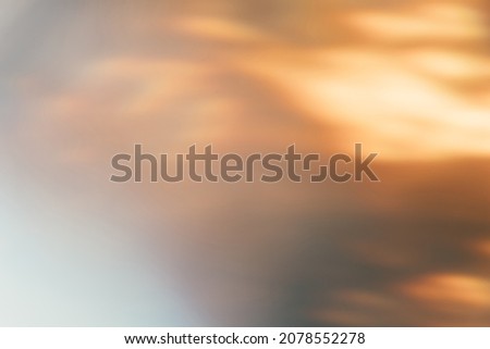 Light flare filter. Blur glow overlay. Sunlight reflection. Bokeh radiance. Defocused orange white color flames texture abstract background.