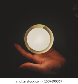 light float on hand with black background 