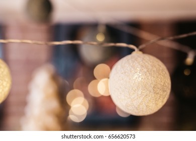 Light in form of knitted ball hangs on the ceiling