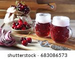 Light fruit craft beer and cherry on wooden chopping board, rustic style