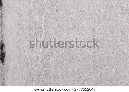Light gray concrete wall texture with subtle surface imperfections, abstract background for design and construction projects. Grunge wall texture with subtle cracks and surface irregularities, abstract construction material background. 