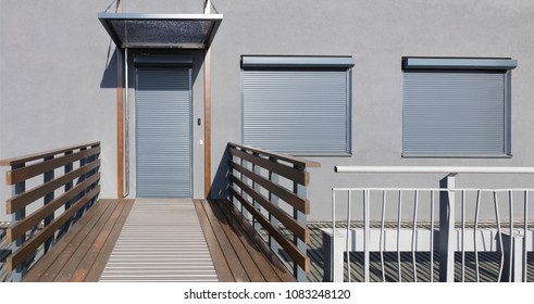 Light Gray Metal Blinds On The Doors And Windows Of The House