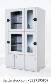 Light gray wall-mounted lockable laboratory storage cabinet against a pure white background