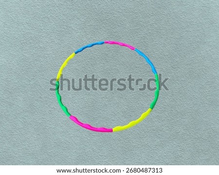 The light green background in the image is a circular hula hoop Colorful circles are used to rotate around the waist for indoor exercise for good health and to maintain a good figure.