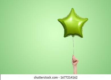 Light Green Birthday Balloons With Copy Space For Text. Star Shaped Balloon Isolated On Green Bright Background.  Festive Background For Party. Stylish Birthday Party Or Holidays Decorated Balloon