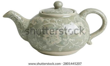 Light green celadon ceramic teapot with intricate floral relief pattern