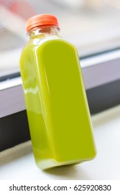 Light green cold pressed juice close up in bottle