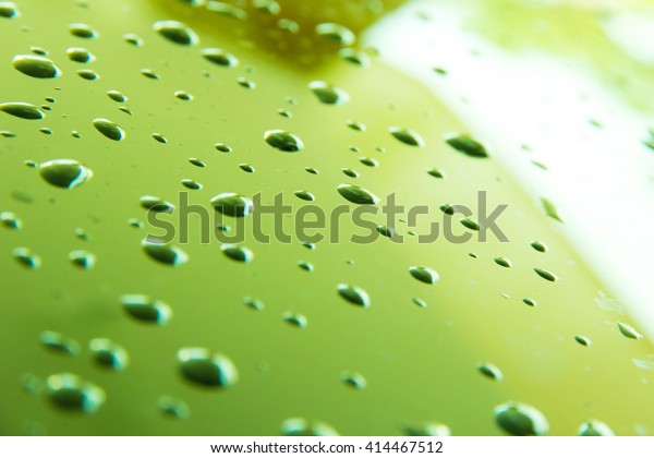 light green drop of water in\
glass