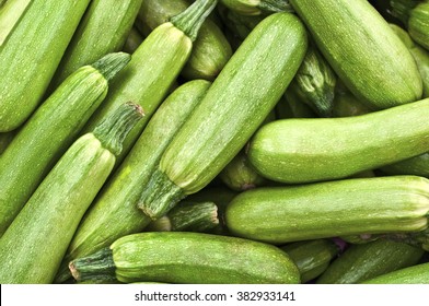 Light green fresh zucchini stacked in a heap shot from above