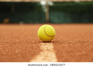 Light Green Tennis Ball On Clay Court, Close Up