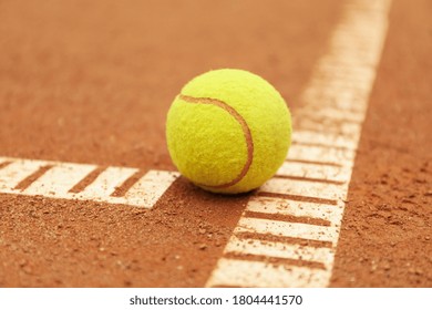 Light Green Tennis Ball On Clay Court, Close Up