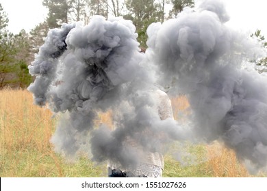 light grey smoke bomb in hay field 