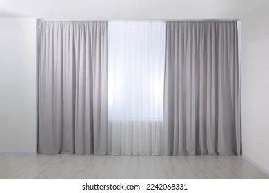 Light grey window curtains and white tulle indoors