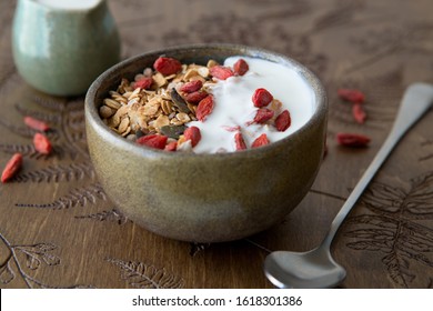 light healthy breakfast, granola, yogurt, goji on the table - Powered by Shutterstock