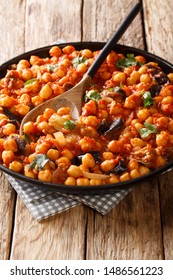 Light And Healthy Vegan Entree With Chickpeas, Eggplant, Tomatoes, Onions And Spices. Traditional Middle Eastern Druze Recipe Closeup On A Plate On The Table. Vertical
