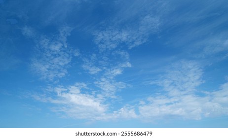 Light high clouds slide on sky. Layer of clouds in blue sky moving horizontal in opposite direction. Timelapse.
