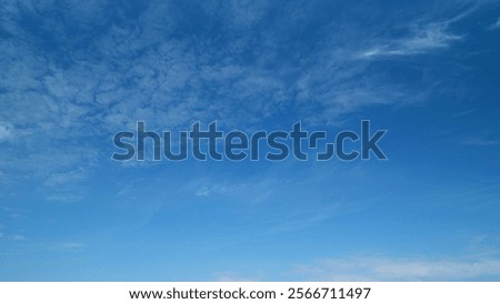 Light high clouds slide on sky. Layer of clouds in blue sky moving horizontal in opposite direction. Timelapse.