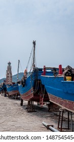 Light house and boats waiting to be repaired in Dalian port, China, 22-8-19