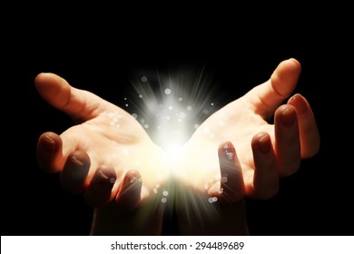 Light in the human hands in the dark